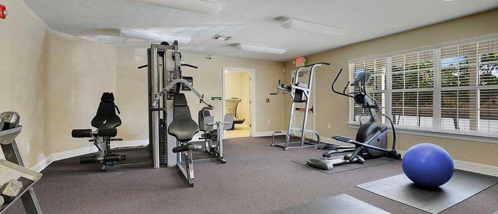 Fitness Center with machines, cardio equipment, and exercise ball at Canterbury house apartments in Baton Rouge